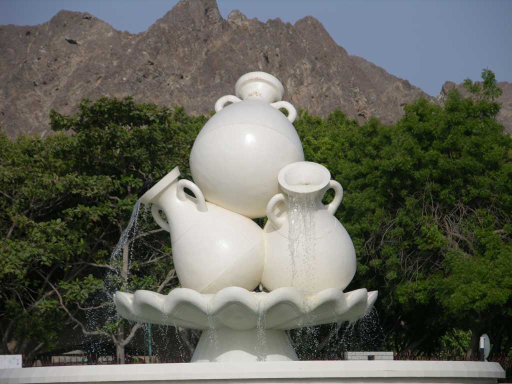 Muscat 03 Mutrah 02 Roundabout Water Pots A roundabout featuring three pots overflowing with water sits at the eastern end of the corniche, as we entered Mutrah.